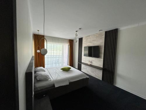 a bedroom with a bed and a large window at Elbram House in Dubova