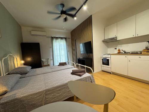 a large bedroom with a bed and a kitchen at Bentley Floriana Suites in Il-Furjana