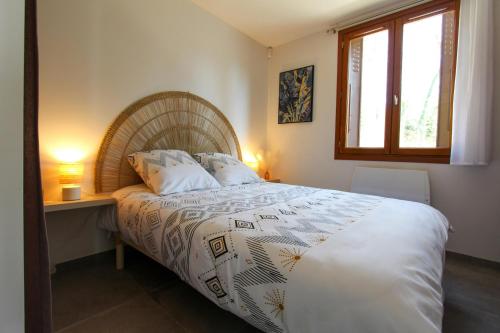 Un dormitorio con una cama y una mesa y una ventana. en Eau petit bois Maison bord du loing with canoë, en Bourron-Marlotte