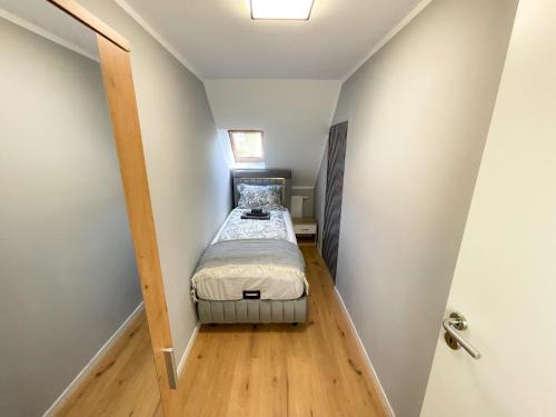 a small bedroom with a bed in a room at Atlas-Apartment in Magdeburg