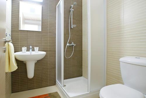 a bathroom with a shower and a toilet and a sink at Too Coool 1 Bedroom Apartment Coralli Resort in Protaras