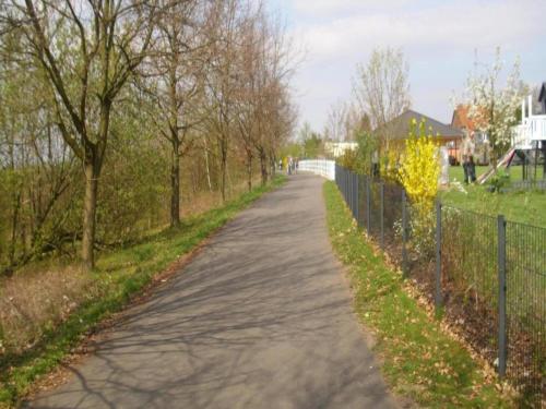 a road with a fence on the side of it at Terrace Apartment Saxony in Eilenburg
