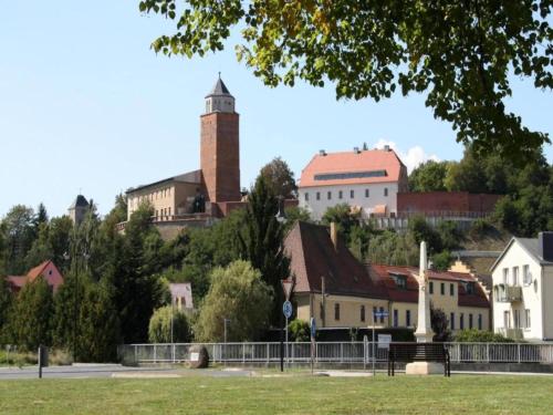 a town on a hill with a clock tower at Terrace Apartment Saxony in Eilenburg
