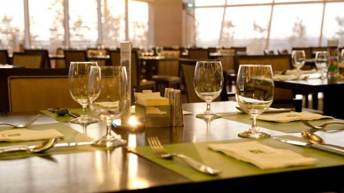 a table with wine glasses on a table in a restaurant at Holiday Inn Gwangju by IHG in Gwangju