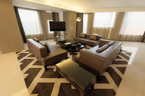 a living room with two couches and a television at Holiday Inn Gwangju by IHG in Gwangju