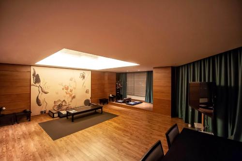 a living room with a couch and a television at Holiday Inn Gwangju by IHG in Gwangju