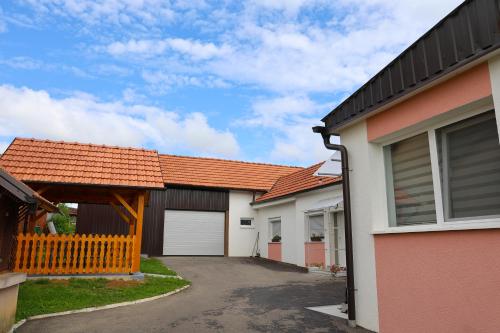 a row of houses with orange roofs and a driveway at Kuća za odmor Marof in Sveti Martin na Muri