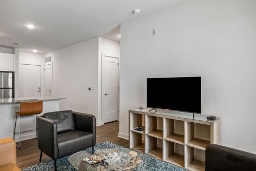 a living room with a flat screen tv on a wall at Spectacular Apartments by BCA Furnished Apartments in Atlanta