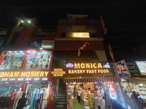a group of shops in a city at night at Hotel O Nabhyansh Elite Lokmanya Nagar railway station in Indore