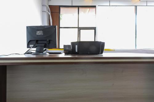 a desk with a computer on top of it at Hotel O Nabhyansh Elite Lokmanya Nagar railway station in Indore
