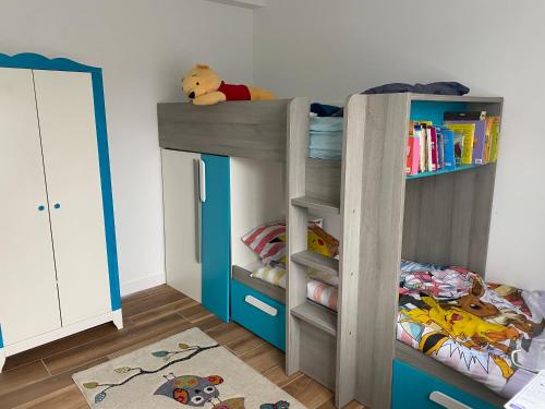 Ce lit superposé se trouve dans un dortoir doté d'une étagère. dans l'établissement Maison récente au coeur du village historique, à Locronan