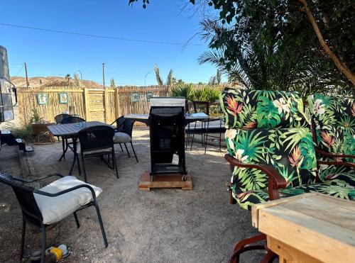 a patio with tables and chairs and a couch at Gilligan's Island Fishing Jetski Shipwreck Oasis in Bullhead City