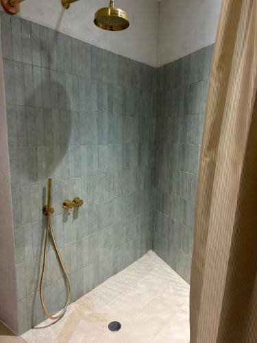 a shower with a shower curtain in a bathroom at Ses Terrisses Hotel in Palafrugell