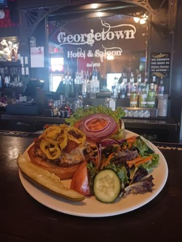 a plate of food on a table in a bar at Georgetown Hotel and Saloon in Georgetown