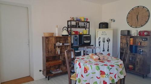 Zimmer mit einem Tisch und einem Kühlschrank in der Unterkunft L'Auberge in Saint-Martin-dʼArmagnac