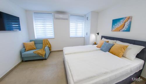 a bedroom with a bed and a couch and windows at Stari View-Free Parking in Mostar