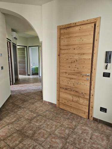a hallway with a wooden door in a house at A casa di Thelma in Barolo