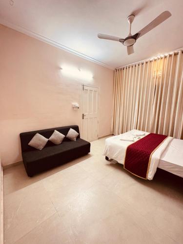 a bedroom with a bed and a ceiling fan at 3BHK Kamla Luxury Villa, Edappally, Near Lulu & Amrita in Ernakulam