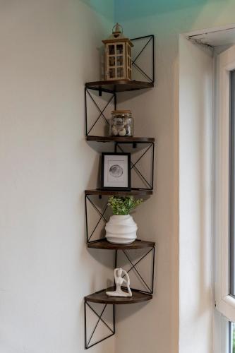 a shelf on a wall with a vase on it at Modern Cozy Apartment With Stars in Weiden