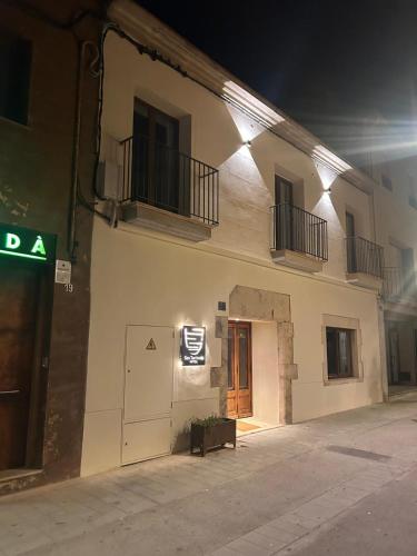 a building with a sign on the side of it at night at Ses Terrisses Hotel in Palafrugell