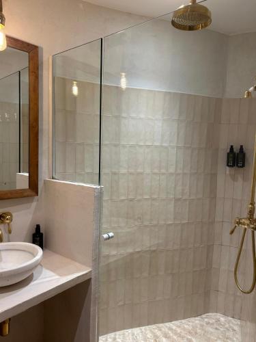 a bathroom with a shower and a sink at Ses Terrisses Hotel in Palafrugell