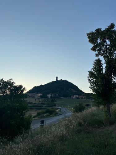 a hill with a castle on top of it at Tuscany Love Apartment in Radicofani