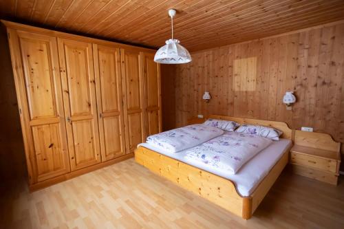 a bedroom with a bed in a wooden room at Appartements Willi in Schoppernau