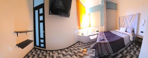 a hotel room with a bed and a sink at CLUB 33 FIT Hotel Gym in Huancayo
