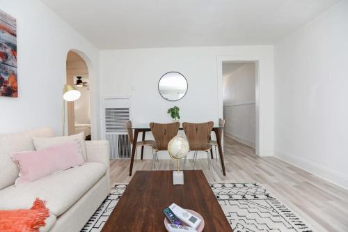 a living room with a couch and a table at Sojourn on the Bay 2 BR Private Beach Access in Norfolk