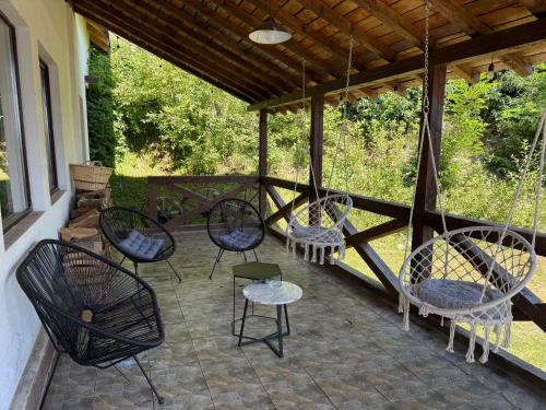 a group of chairs and tables on a patio at Panoramic House in Mărişel