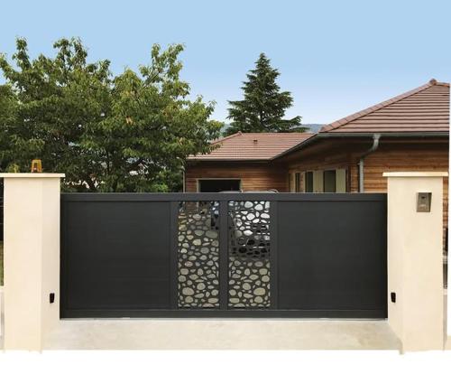a black gate in front of a house at Villa tranquille in Ouagadougou