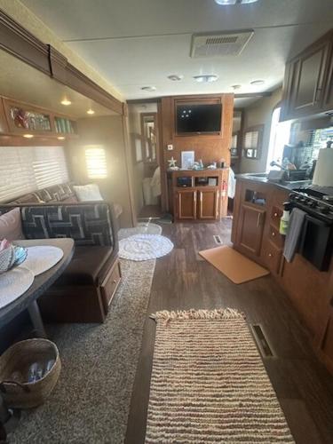 a living room with a couch and a kitchen at Fisher Paradise Oasis on the River in Bullhead City
