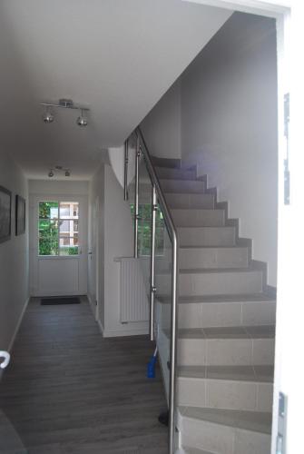 a hallway with a staircase in a house at Haus Adria in Schleswig