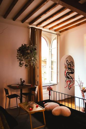 a living room with a table and a window at Lunar artistic loft in Pisa