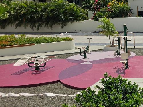 a pink and purple rug with a chair on it at Boutique appartment 4P with PRIVATE POOL, near Jan Thiel & Mambo beach in Willemstad