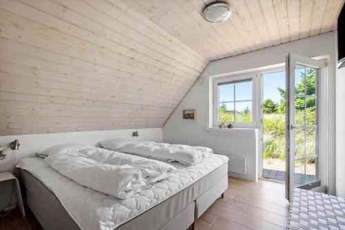 a large bed in a room with a window at 1126-Ringkobing-Frans-Julius-Vej-44 in Ringkøbing