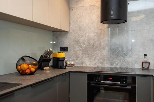 a kitchen with a counter with a bowl of fruit at Seaside Escape in Split