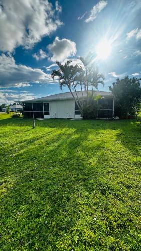 a house with a palm tree in a field at canalfront near beaches private home remodeled in Rotonda West