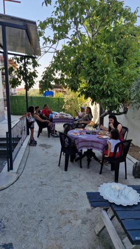 a group of people sitting at tables in a park at Mery Inn in Pamukkale
