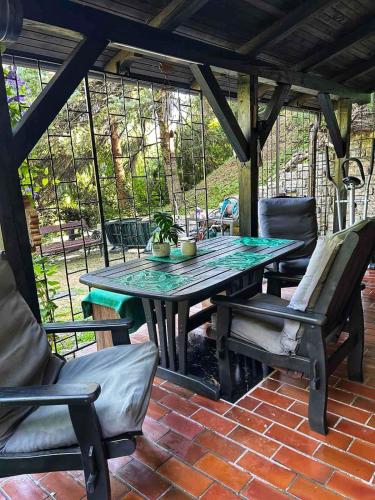 a table and chairs on a brick patio at Šumska Bajka in Orahovica