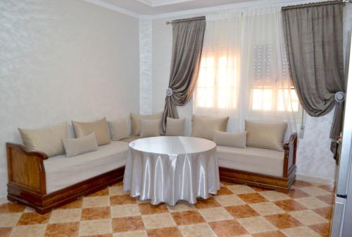 a living room with a couch and a table at Apartment 5 min Corniche in Nador