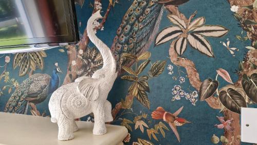 two white plastic dinosaurs on a table in a room at The Yoke Apt Peaceful Private Garden views in Ballybrittas