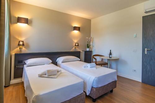 a room with two beds and a table at Montelleri Residenza di Campagna in Vicchio