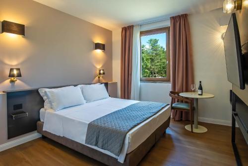 a hotel room with a bed and a window at Montelleri Residenza di Campagna in Vicchio