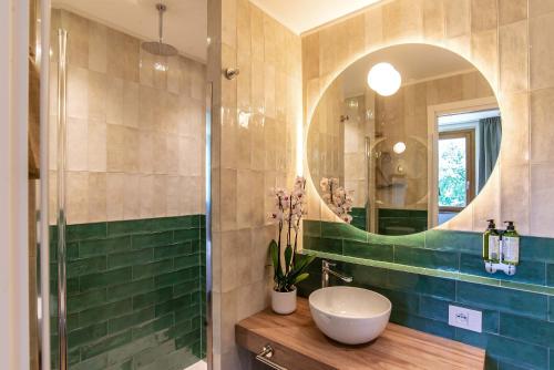 a bathroom with a sink and a mirror at Montelleri Residenza di Campagna in Vicchio