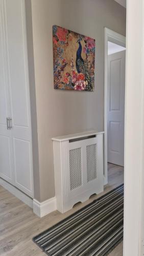 a living room with a radiator and a painting on the wall at The Yoke Apt Peaceful Private Garden views in Ballybrittas