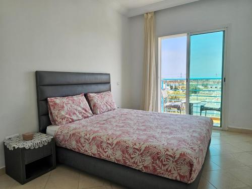 a bedroom with a bed and a large window at Buenavista CaboNegro in Cabo Negro