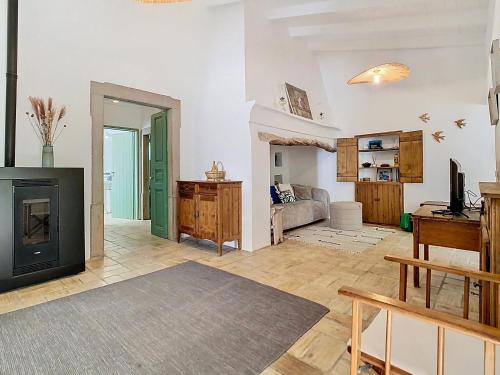 a living room with a fireplace and a couch at Casa Martim in Romão