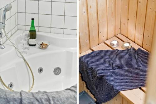 a shower and a bath tub with a bottle of wine at 719-Hvide-Sande-Slusen-19 in Hvide Sande