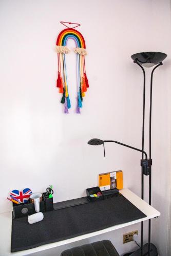 a room with a desk with a rainbow on the wall at ApArt Gallery Apartment 2, Stylish 3- Bed , Free Parking ,Sleeps 6 in Bedford